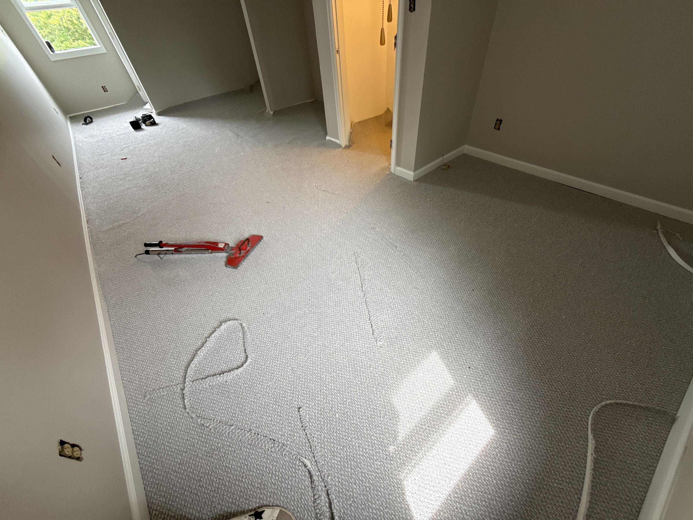 Brewer Custom Floors crew installing carpet in a Central Indiana home