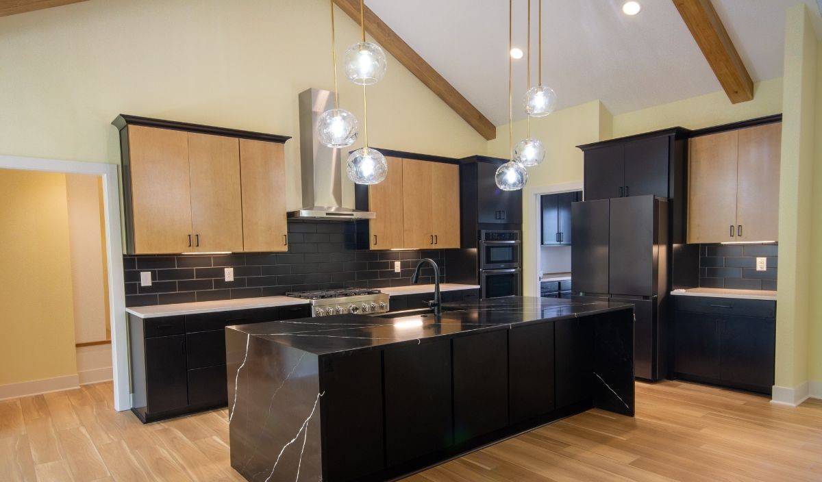 Luxury vinyl plank flooring in a modern kitchen with waterfall island
