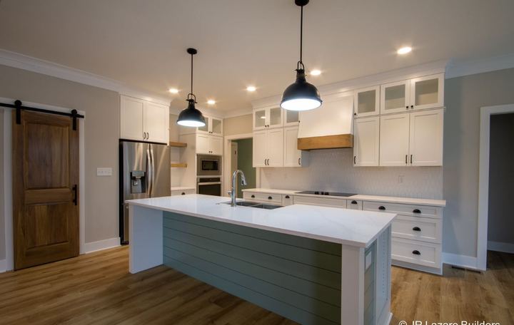 Farmhouse kitchen with white hex tile backsplash, sage shiplap island and wood-look plank flooring