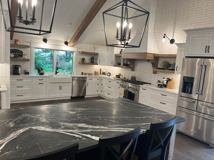 Farmhouse kitchen with white subway tile run to the ceiling, soapstone island and open wood shelving